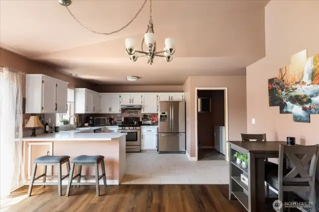 Looking towards the kitchen, dining area, and laundry room