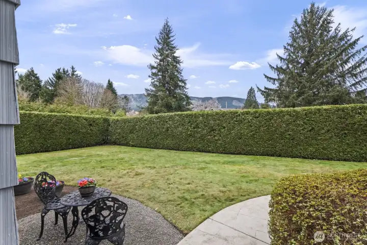 Enjoy a private, beautifully landscaped front yard with expansive green space for relaxing or gathering.