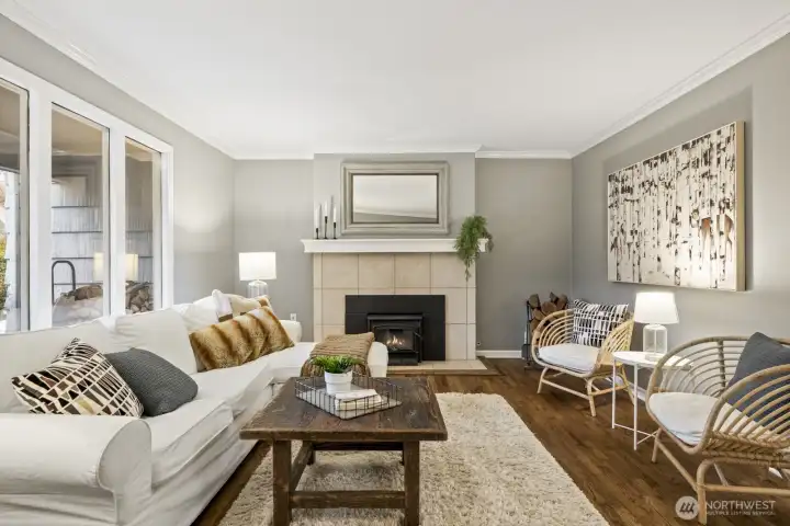 Cozy wood fireplace and floor to ceiling windows in the front living room.