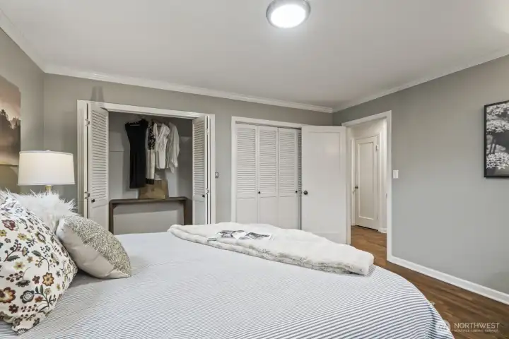 Bright, freshly painted primary bedroom with generous closet space; updated paint extends throughout the home.