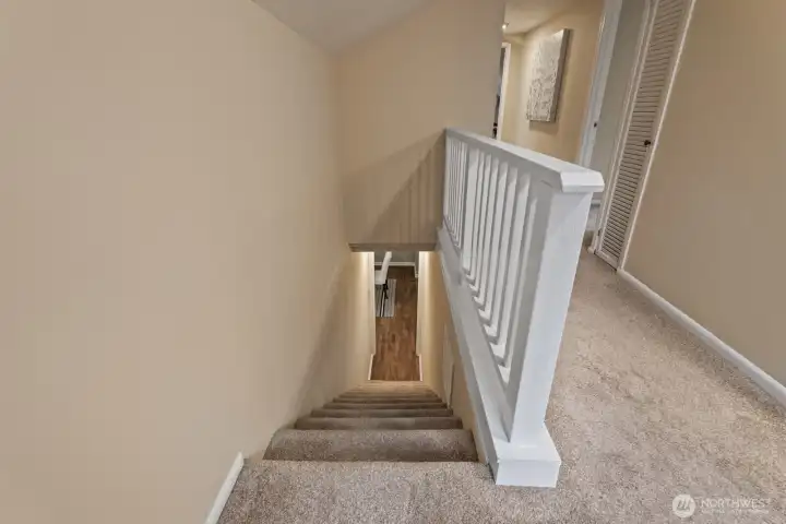Staircase leads to four additional bedrooms, a second full bathroom, and ample storage.