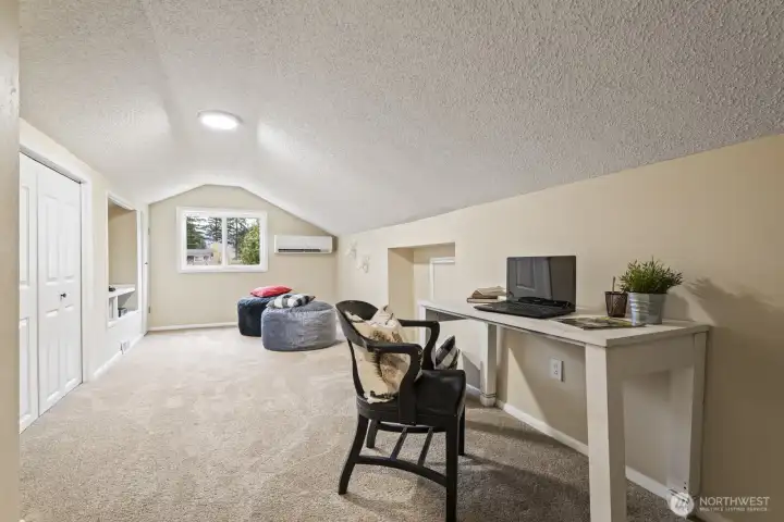 At the end of the hallway, the fourth bedroom or playroom features ample built-ins and closet storage.