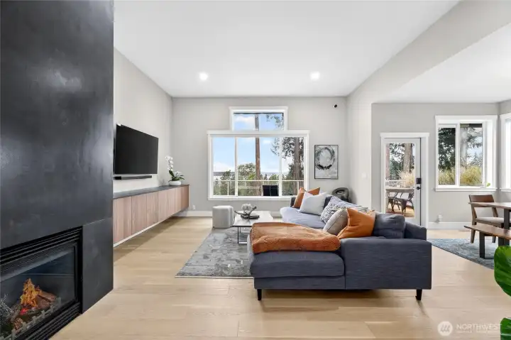 Main level living room w/gas fireplace, built in cabinetry, tv stays