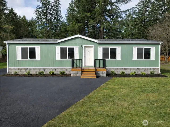 Digitally enhanced: landscaping, gravel, skirting, and deck added. Actual conditions may vary.