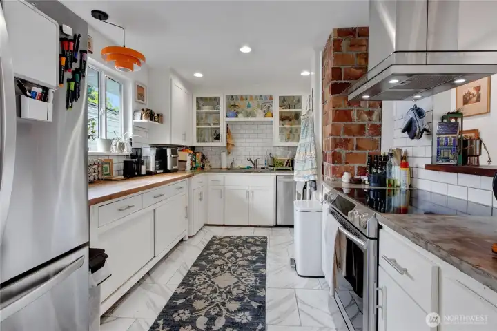 Beautifully updated kitchen featuring stainless steel appliances and generous cabinet storage