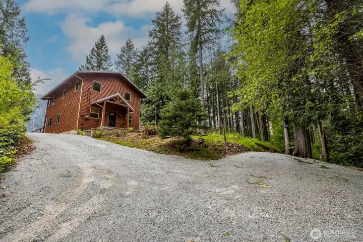 Fresh gravel driveway with room to park multiple vehicles.
