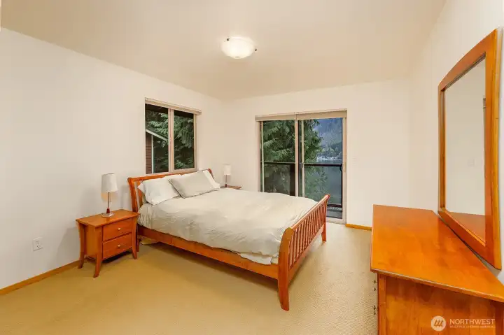 Upper level bedroom also has deck with lake views.