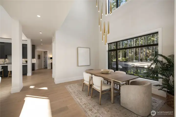 Dining space with a 15 ft gorgeous Mod lighting fixture. Wide plank European Oak floors.