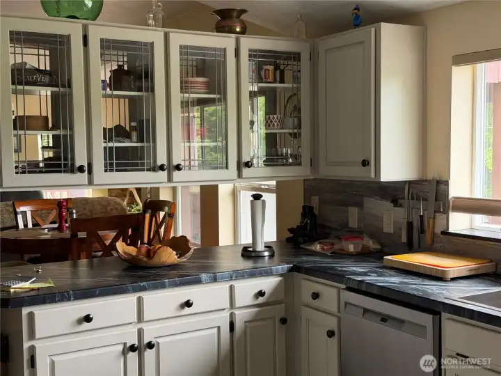 Standing at opposite end of kitchen