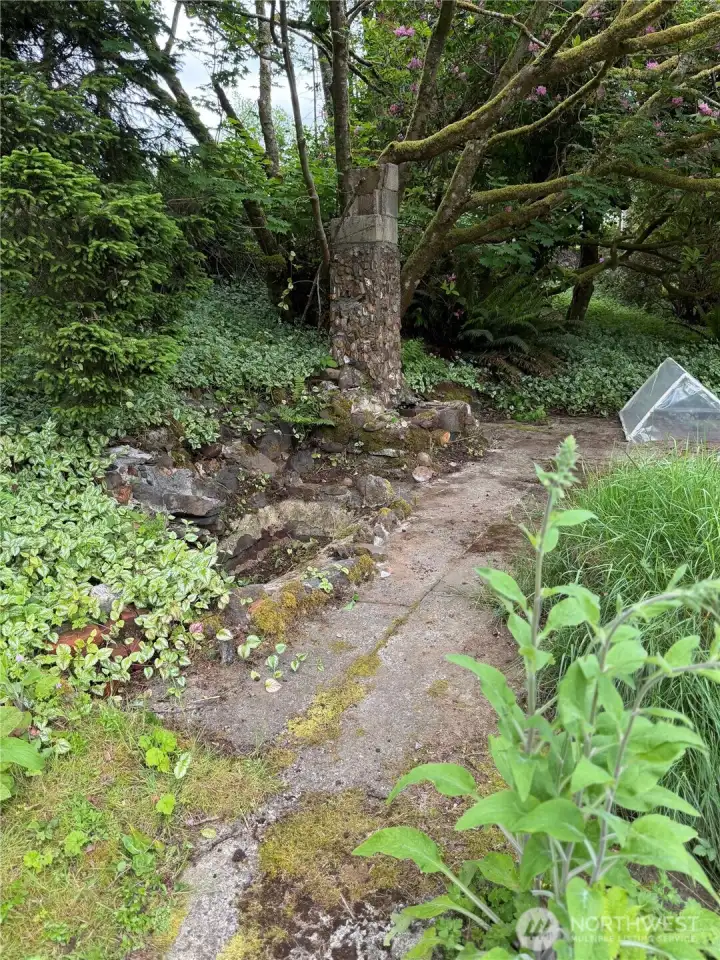 Future pond and adobe fireplace existing from original home slab, great meeting area.