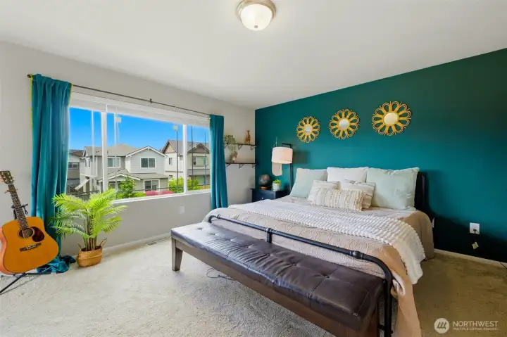 Primary bedroom has a beautiful view of the open community gathering space.
