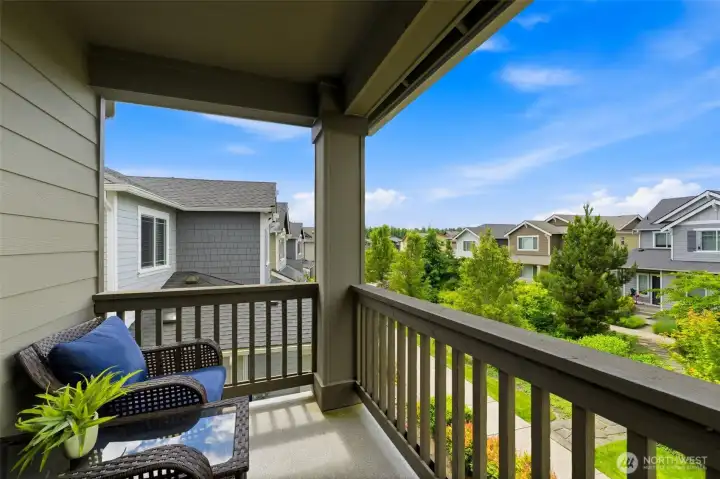 Primary bedroom has a great private balcony with views of the perfectly maintained community open space!