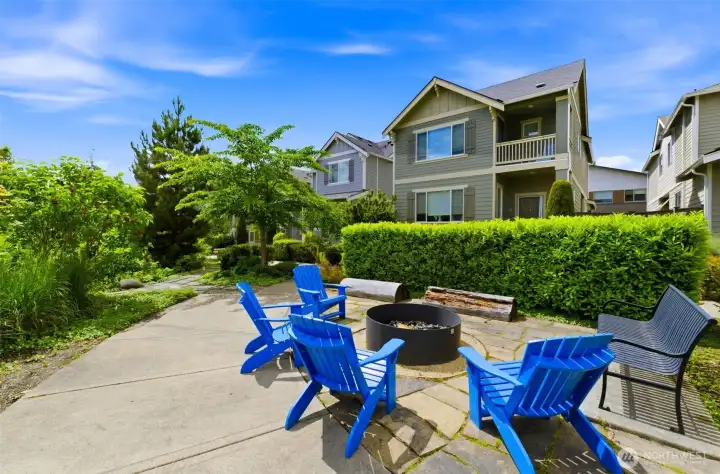 Right outside your front door is the open space with fire pit. Families gather and safely play!
