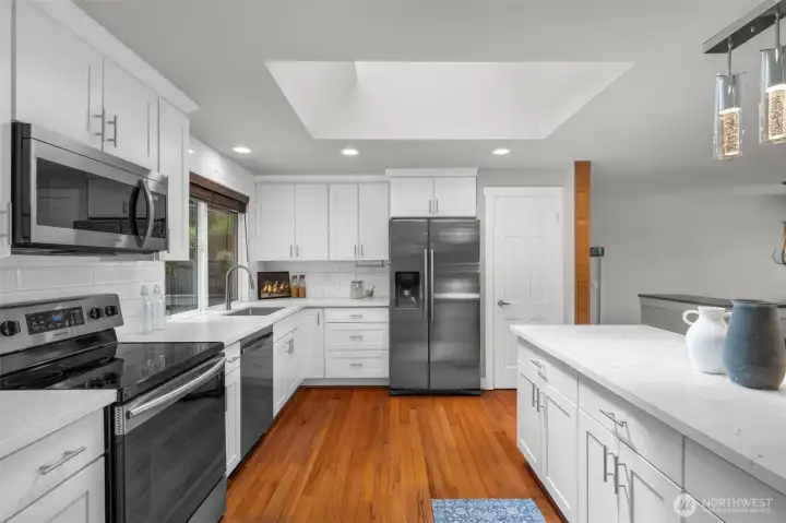 Beautifully updated kitchen showcasing sleek white cabinetry and a spacious central island