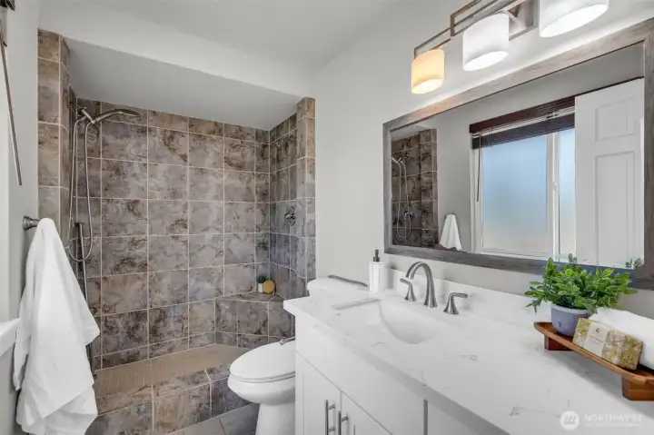 Beautifully remodeled primary bathroom with premium finishes and a spacious walk-in shower