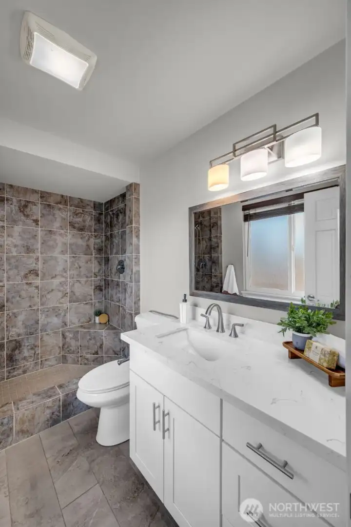 Another view of the tastefully updated primary bathroom