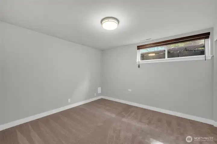Spacious 5th bedroom located on the lower level, ideal for guests or a home office
