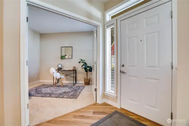 A transom window shines extra light onto the entry hall and double doors lead to the bonus room. Keep in mind all the Luxury Vinyl Plank flooring and carpeting is brand new.
