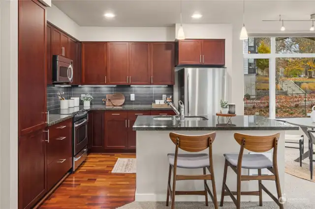 Kitchen has cherry cabinets and wood floor