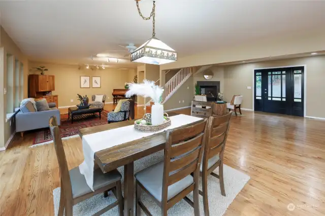 View of the front door, stairs and entry area as well as large living space.