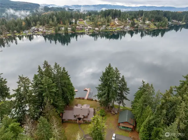 Aerial view of the lake, home and dock area.