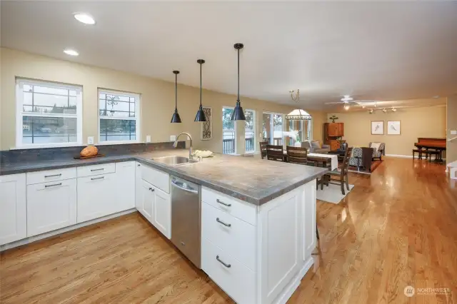 Beautiful kitchen counters and a view of the lake with a full view of the folks in the living room.