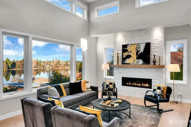 Beautiful Natural Light Pours In via the Great Room Huge Picture Window and 14' Windowed Ceilings, Gather around the 48" Gas Fireplace with Alabaster Stone and Wood Mantel Complete with TV Hookups.