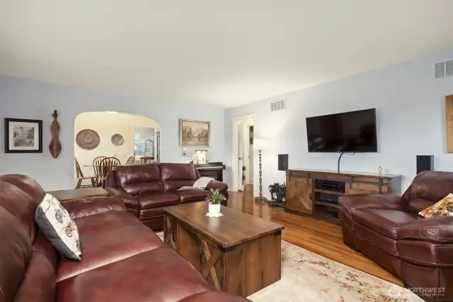 Spacious living room leads to dining and hallway