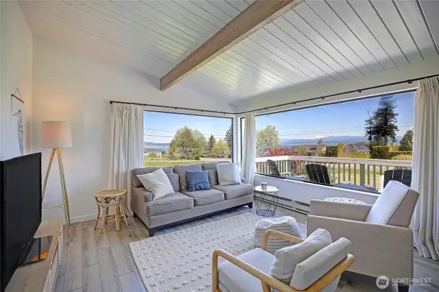 MCM w/Boho modern feel throughout this perfectly renovated home! Wrap around windows soak in the sound and mountain views!