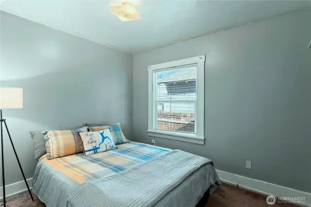The main bedroom easily accommodates this queen sized bed. (A king sized would fit, too.)