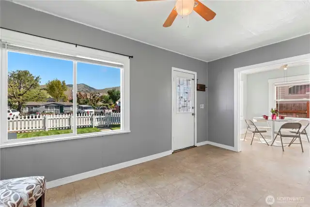 That big picture window offers nice vistas. The living room opens to the dining room.