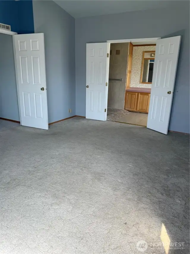 Primary bedroom looking into primary bath.
