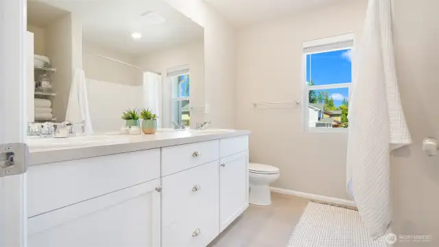 The main hall bath is so spacious... and look in the mirror, yes! there are storage shelves here too.