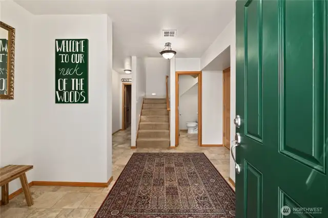 Tiled entry features a half bath and garage access.