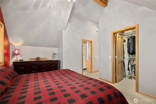 Walk-in closet with additional access to storage.