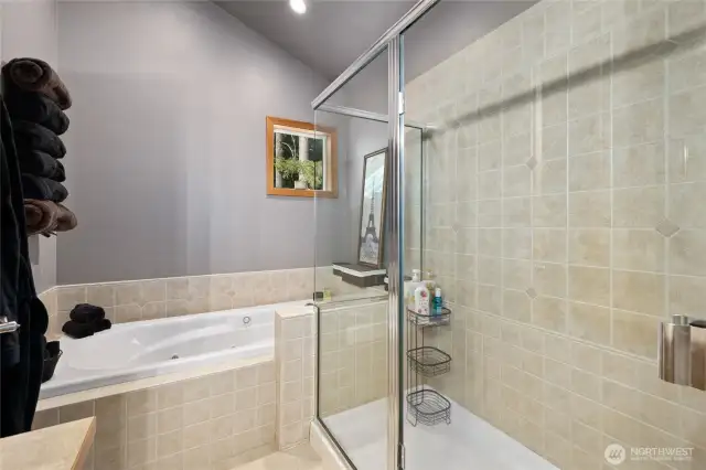 Primary bathroom with a relaxing jetted tub and a sperate glass shower.