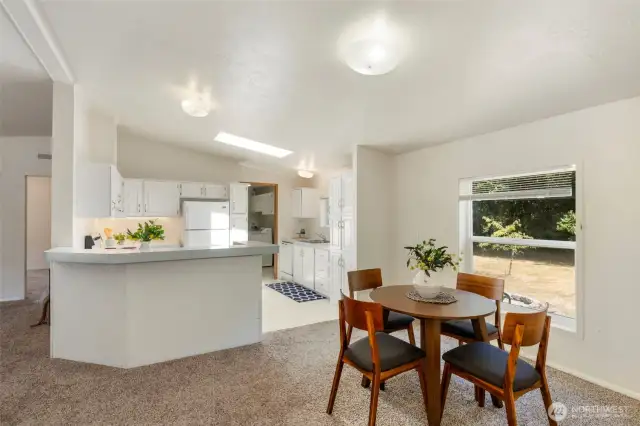 Light and bright kitchen with skylight and white cabinets.