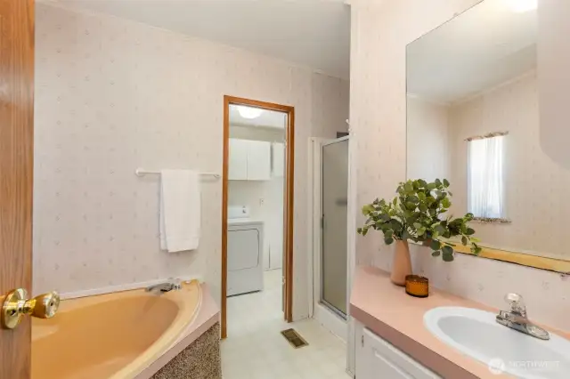 Bathroom with soaking tub, shower and vanity.