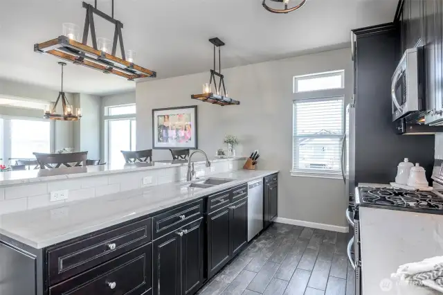 Designer kitchen blends refined elegance with functionality, framed by captivating glimpses of Puget Sound views.