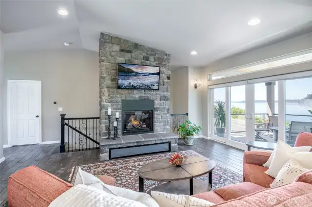 Cozy up by the stone fireplace or step out to panoramic Puget Sound views from the deck.