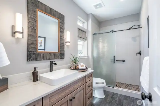 Custom cabinetry, spa-style finishes, and a walk-in shower make this bathroom refreshingly refined.