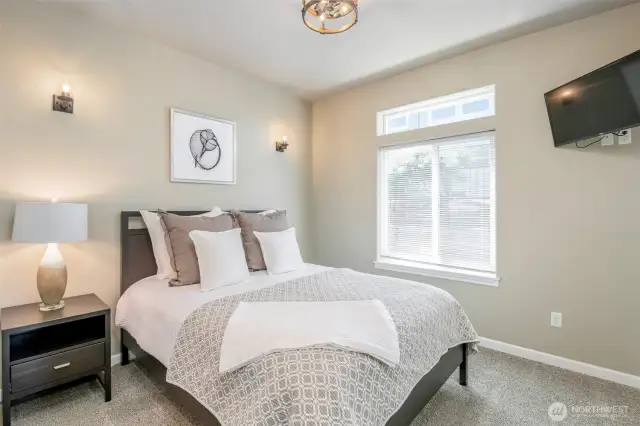 Cozy main floor bedroom retreat with calming tones, plush textures, and natural light to start your day right.