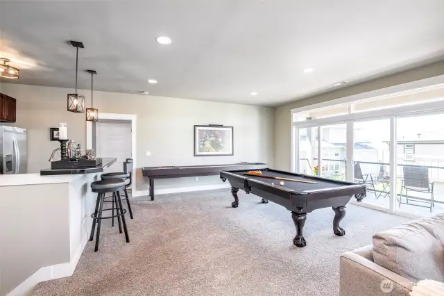 Entertain in style with a refined lounge, bar seating, and a full-size billiards table.