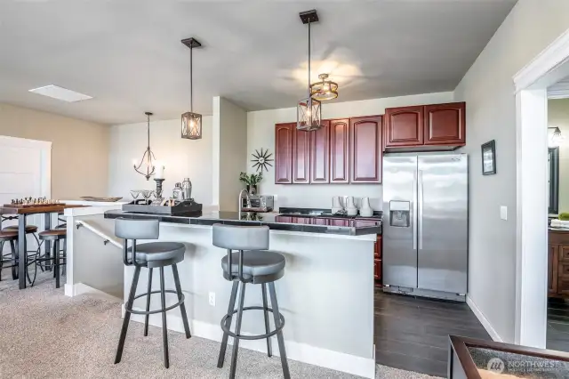 Entertain with elegance in this stylish kitchen-bar space, seamlessly blending comfort and sophistication.