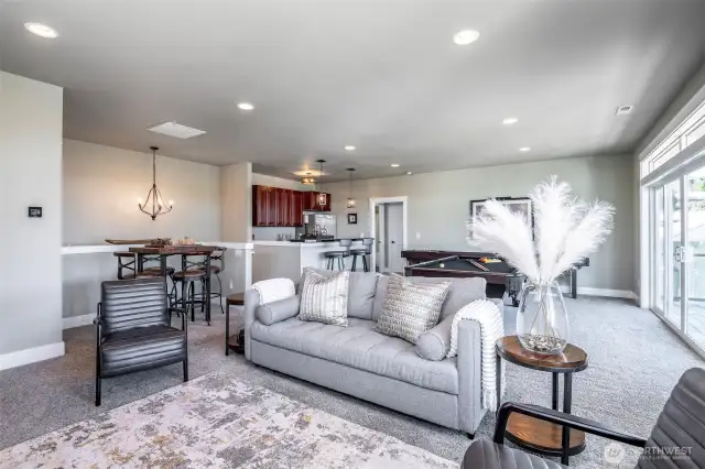 Light-filled guest retreat with game room, sleek bar area, and seamless flow to the view deck.