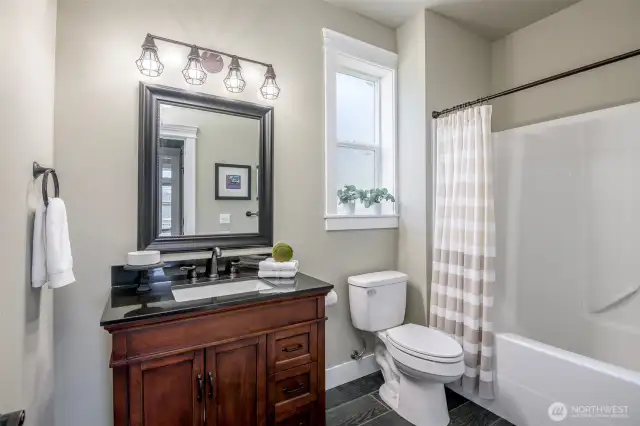 Crisp finishes and classic charm meet in this bright, beautifully updated full bathroom.