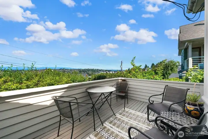 West facing deck at front of the house perfect for coffee and a newspaper in the morning and gorgeous sunsets over the Olympics in the evening. This deck is above the street and offers great privacy.