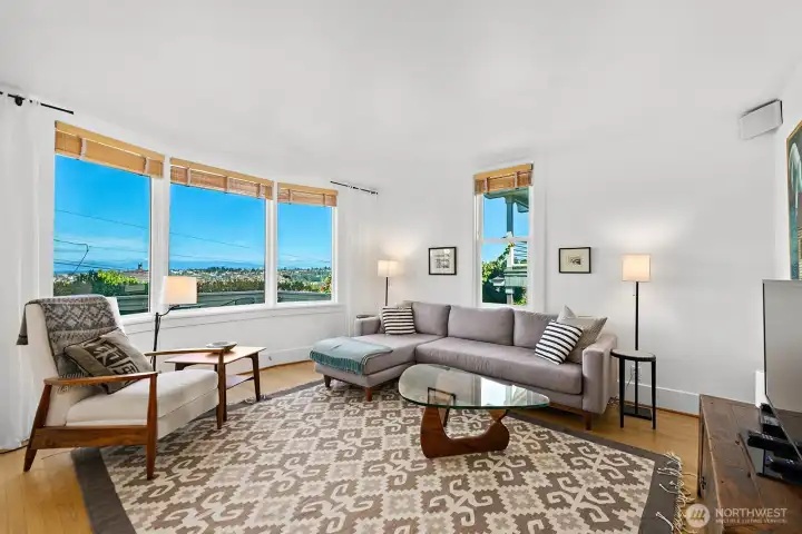 The spacious living room features a wall of west facing windows, so the the unobstructed view of the Olympics is ever present.