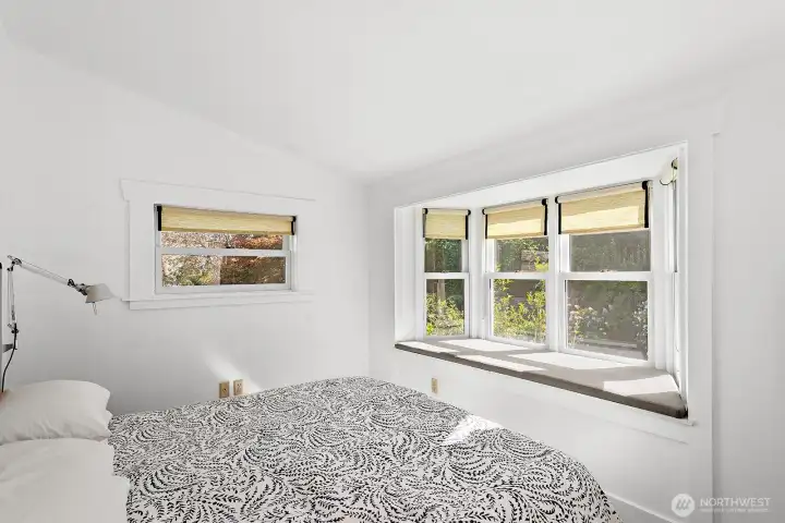 Again, the primary bedroom has a window seat overlooking the gardens.