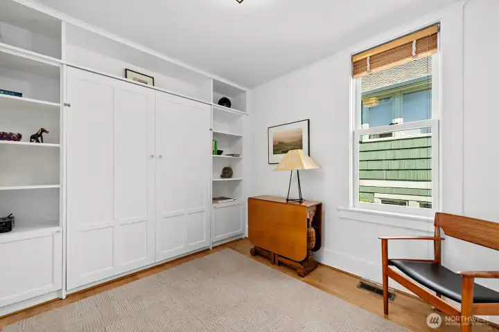 Here you can see the ample floor space available in this guest bedroom when the Murphy bed is tucked away in its cabinet.
